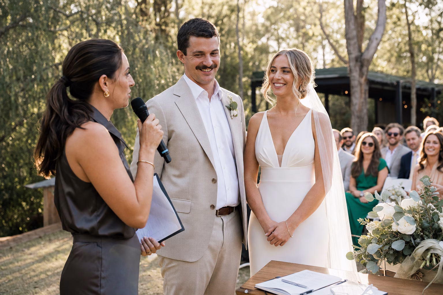 Celebrant conducts an outdoor garden wedding ceremony for a couple