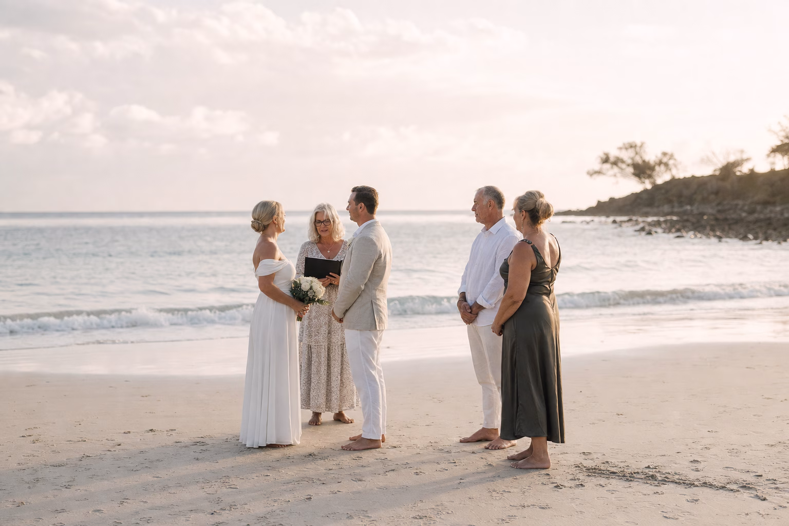 Beach elopement with couple, celebrant and two adult witnesses